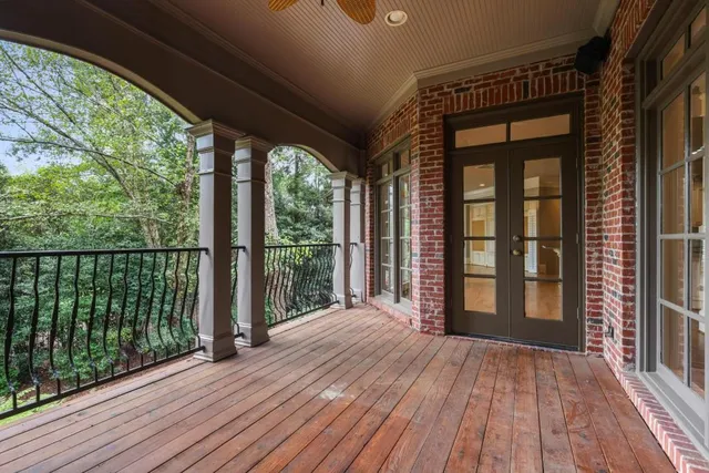 a view of a room with wooden floor and balcony