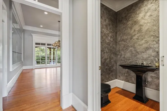 a view of hallway with wooden floor and a carpet
