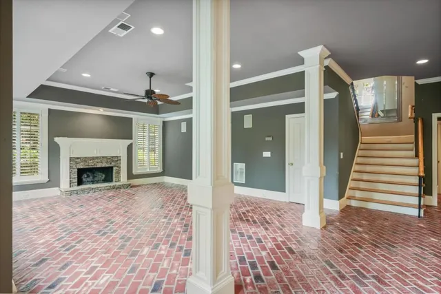 a view of a livingroom with wooden floor and a fireplace
