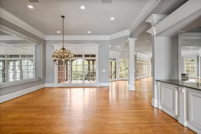 a view of an entryway with wooden floor and door