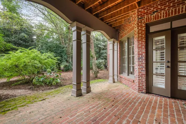 a porch with a table and chairs in front of it