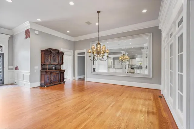 a view of a living room and kitchen with furniture wooden floor and chandelier