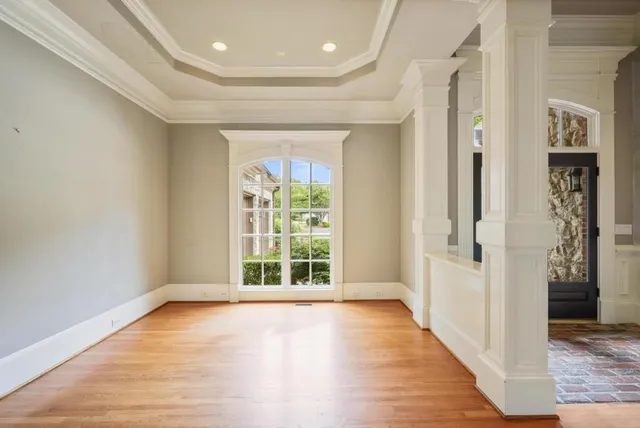 wooden floor in an empty room with a window
