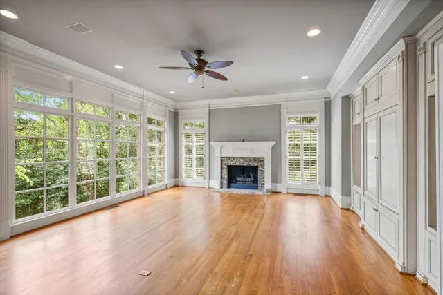 a view of empty room with wooden floor and fireplace