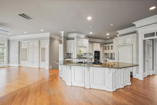 a kitchen with stainless steel appliances granite countertop a sink and cabinets