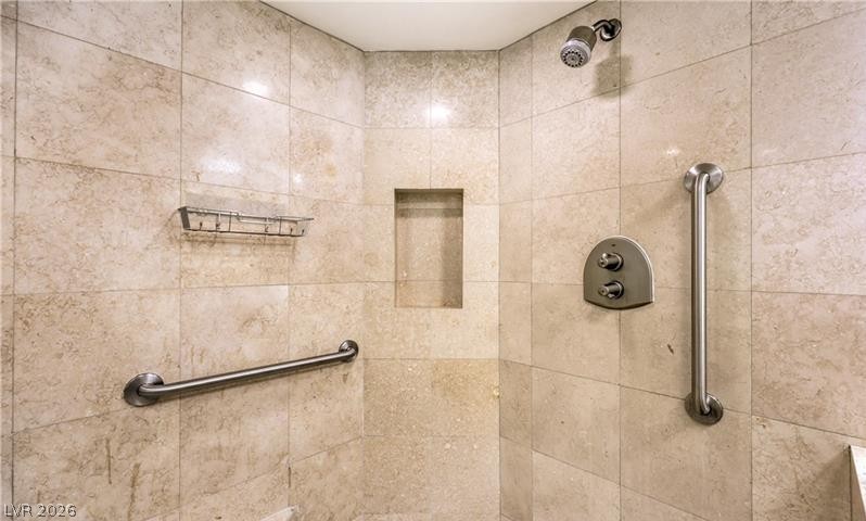 2777 Paradise Road, Unit 807 Las Vegas, NV 89109 - Photo 23 of 61 A well-appointed shower with durable tile, practical grab bars, and a convenient built-in niche.