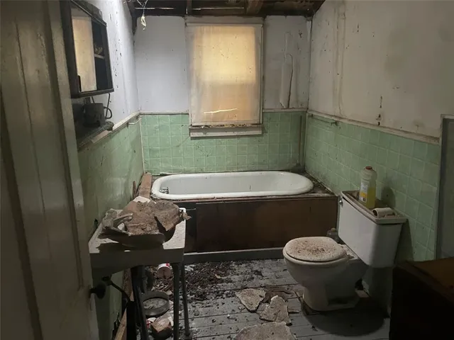 a bathroom with a sink a toilet and bathtub