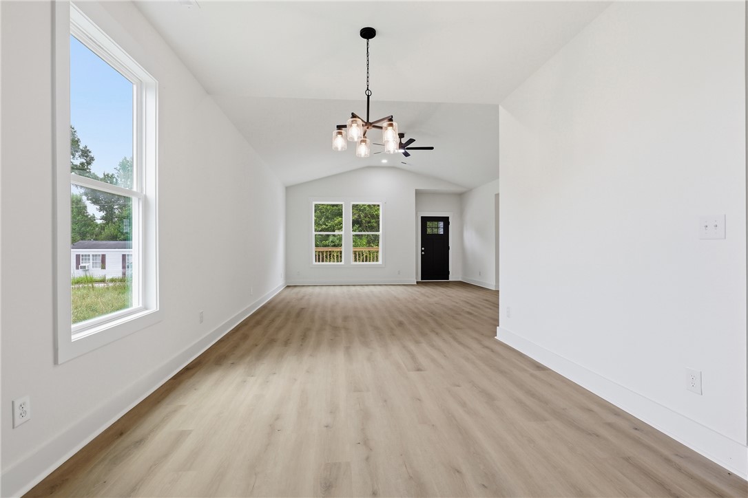 403 Tribble Street Seneca, SC 29678 - Photo 15 of 37 Luminous interior with high vaulted ceilings and beautiful wood flooring, creating an inviting atmosphere.