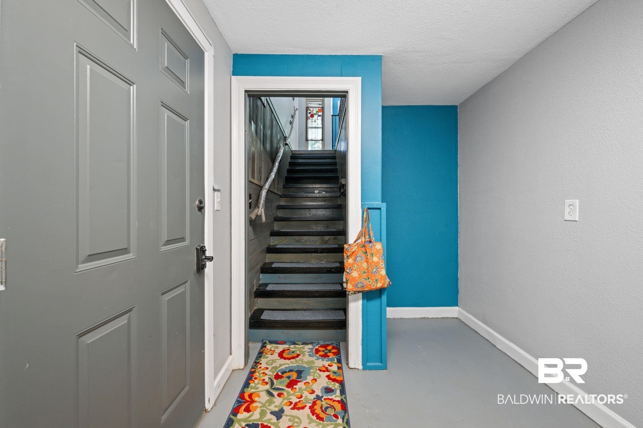 40 Caisson Trace Daphne, AL 36527 - Photo 32 of 54 Stairway featuring concrete flooring and a designated pantry area.