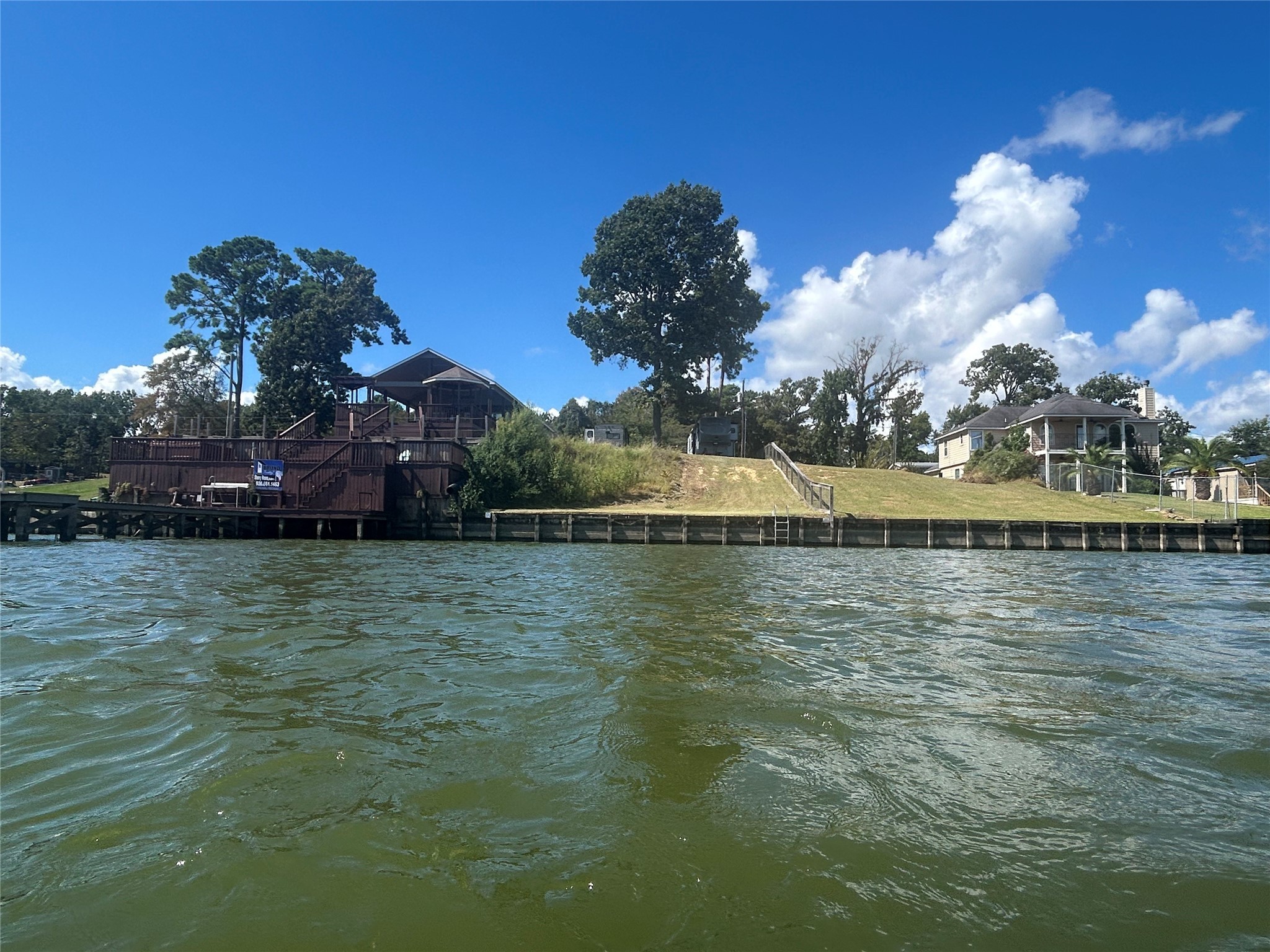 255 Key Largo Loop Point Blank, TX 77364 - Photo 2 of 13 a view of a lake with houses in the background