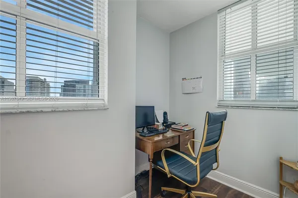 a bedroom with baby crib and a window