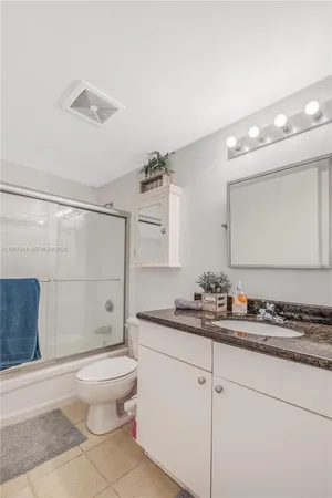 a kitchen with stainless steel appliances granite countertop a refrigerator a stove and a sink