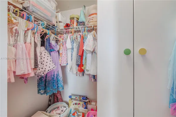a kitchen with kitchen island granite countertop a stove a sink and a microwave