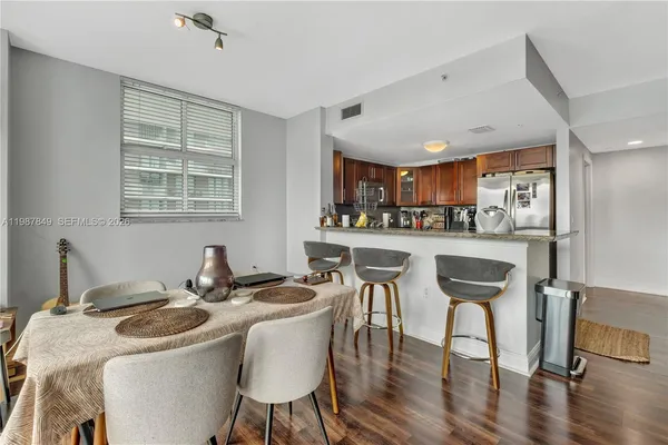 a utility room with dryer washer and a view of living room