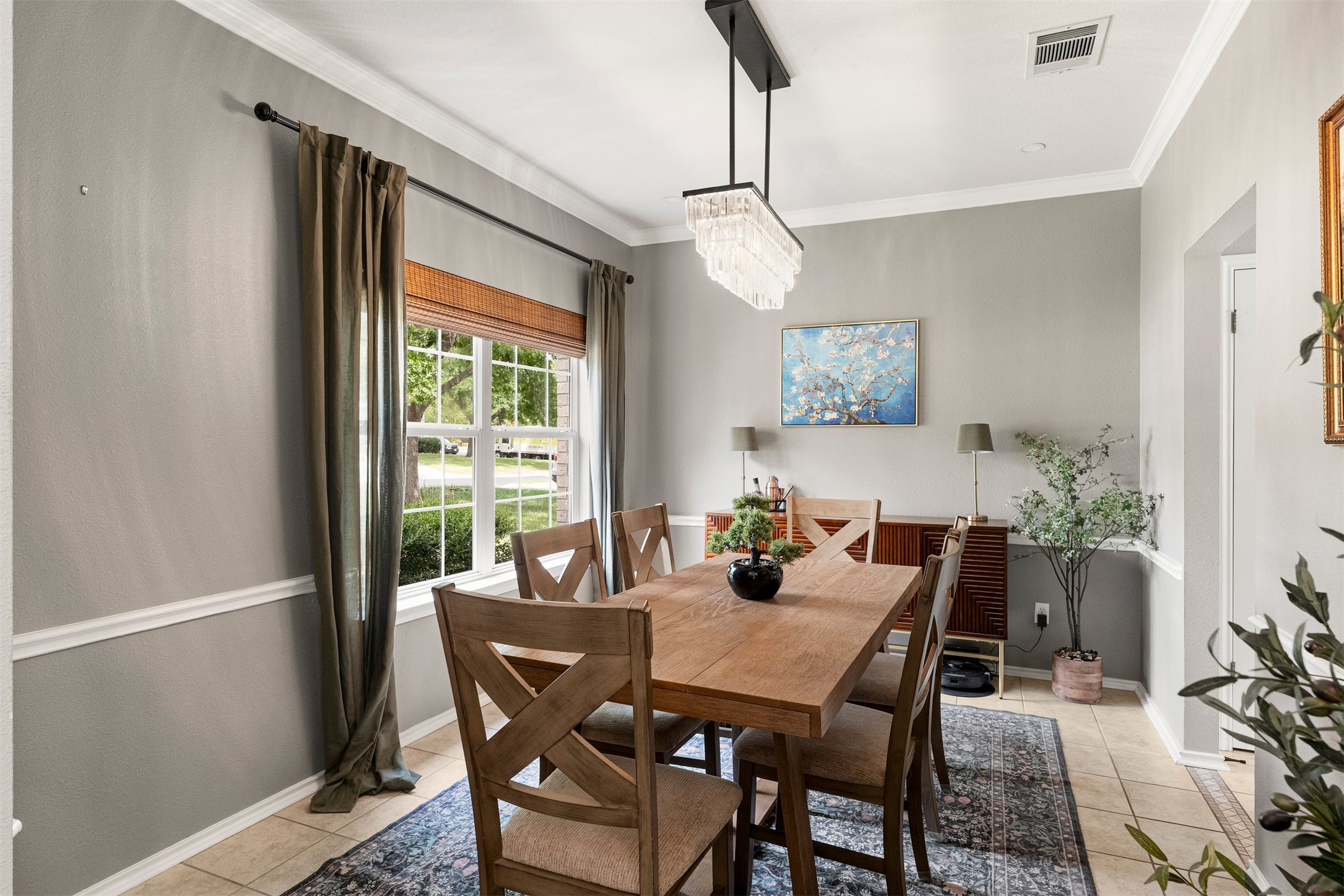 7009 Wandering Oak Road Austin, TX 78749 - Photo 11 of 36 Positioned near the entrance, this dedicated dining space with crown molding and natural window light is ideal for holiday meals, formal dinners, or hosting game nights with friends