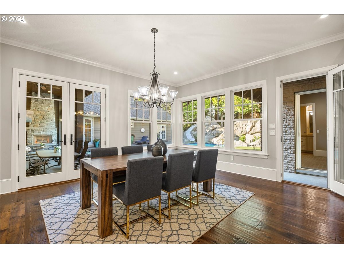 3528 Southwest 64th Place Portland, OR 97221 - Photo 16 of 48 a view of a dining room with furniture wooden floor and chandelier