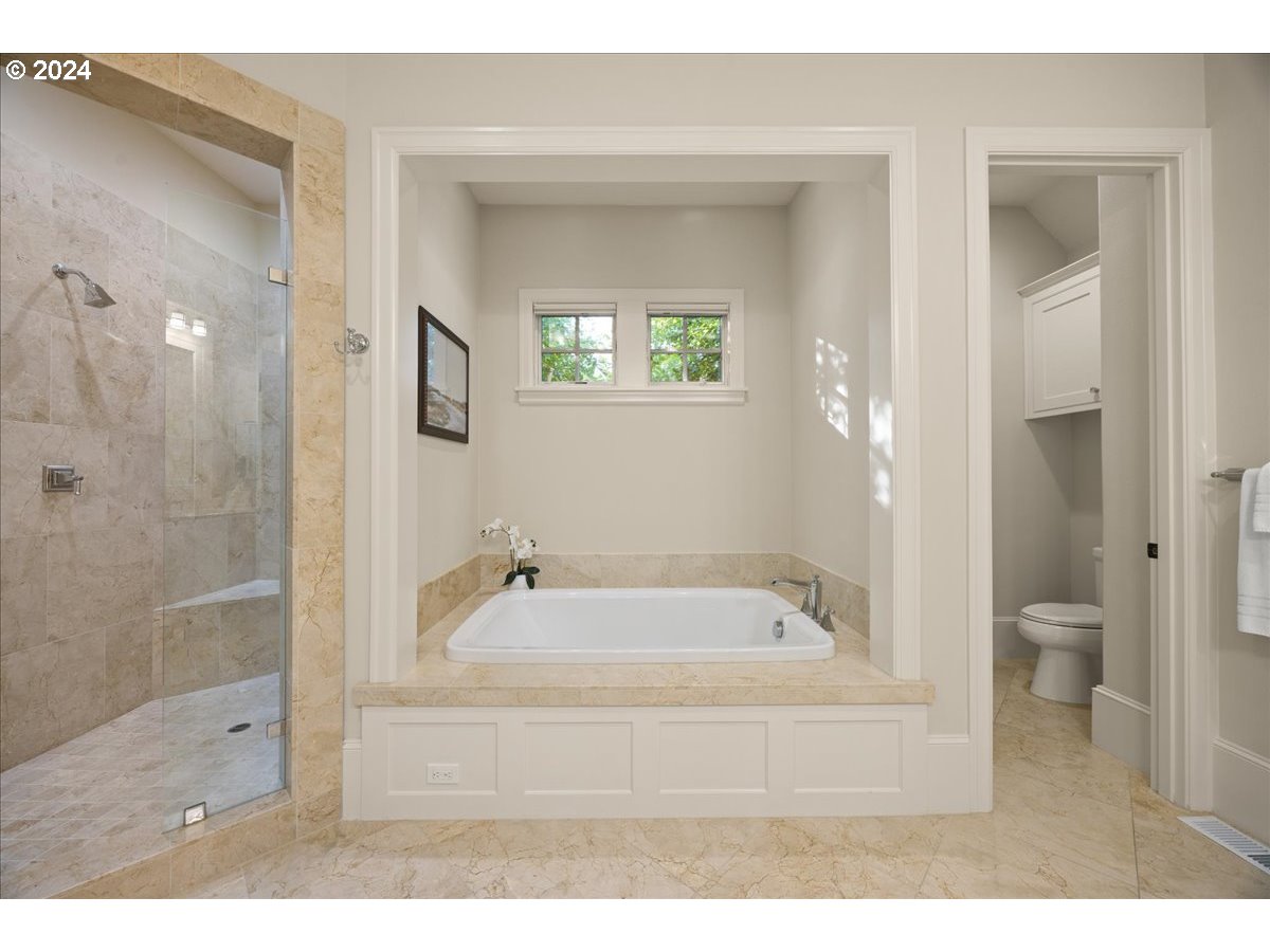 3528 Southwest 64th Place Portland, OR 97221 - Photo 25 of 48 a bathroom with a tub shower sink and mirror