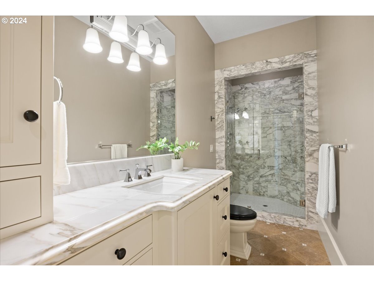 3528 Southwest 64th Place Portland, OR 97221 - Photo 28 of 48 a bathroom with a sink a mirror and a shower