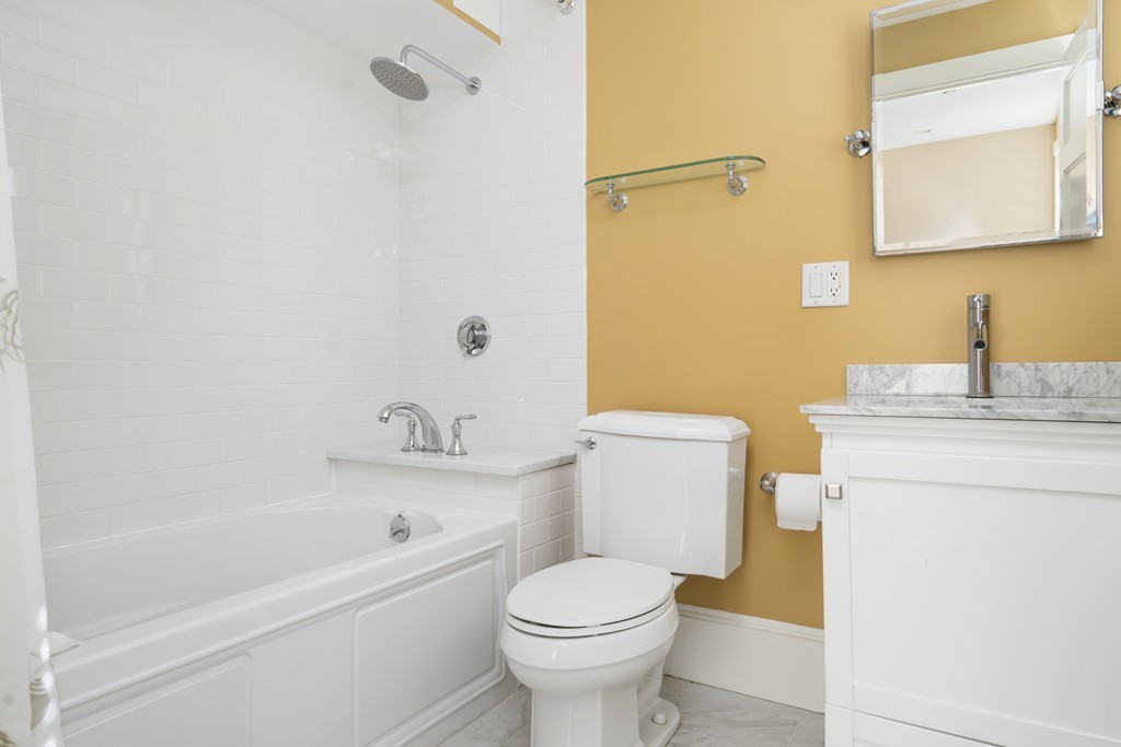 423 Hope Street, Unit 1A Bristol, RI 02809 - Photo 14 of 26 a bathroom with a sink a toilet and a bathtub