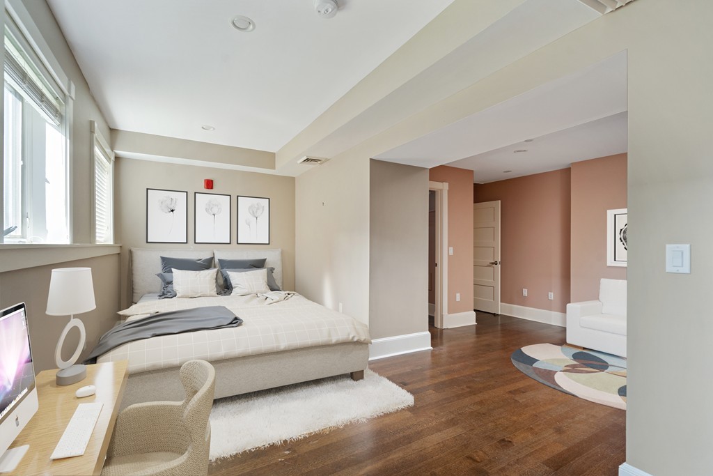 423 Hope Street, Unit 1A Bristol, RI 02809 - Photo 16 of 26 a bedroom with a bed and a large window