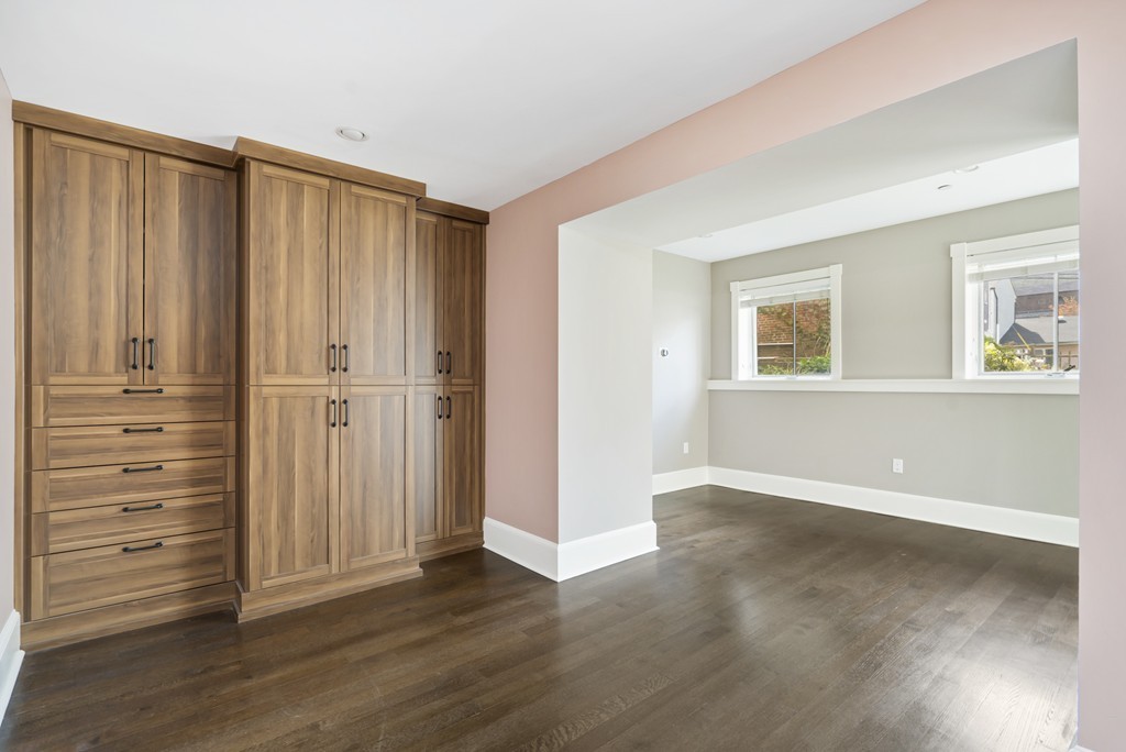 423 Hope Street, Unit 1A Bristol, RI 02809 - Photo 18 of 26 an empty room with wooden floor cabinet and windows