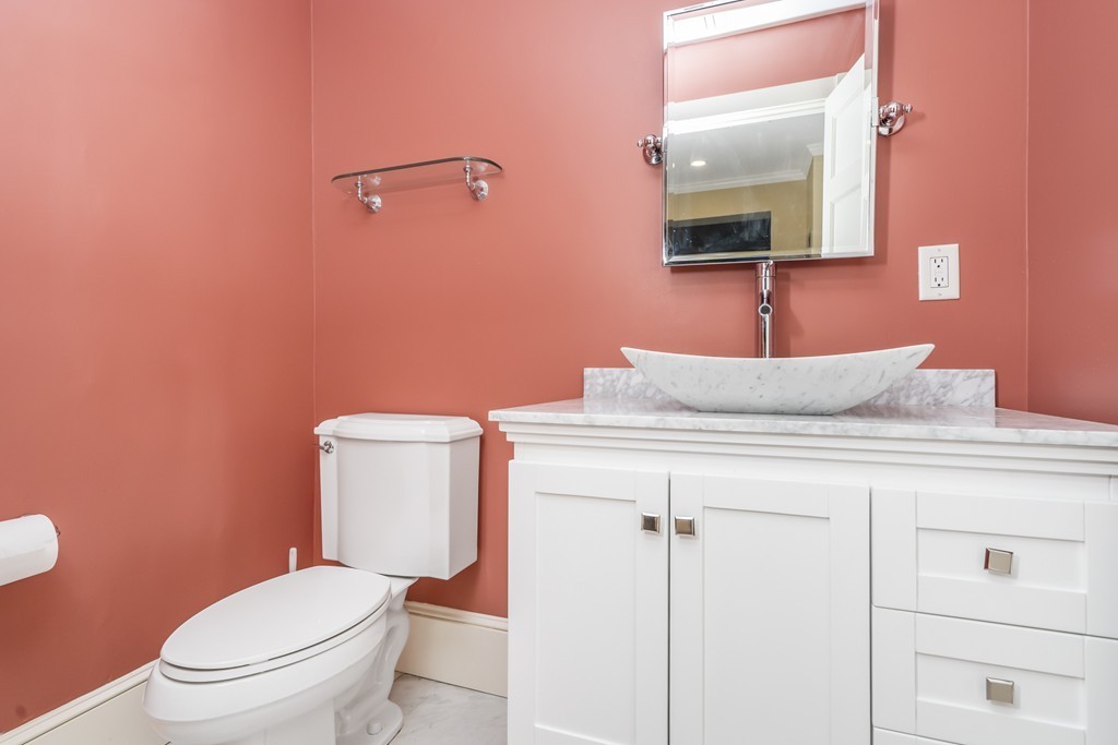 423 Hope Street, Unit 1A Bristol, RI 02809 - Photo 20 of 26 a bathroom with a granite countertop toilet sink and mirror
