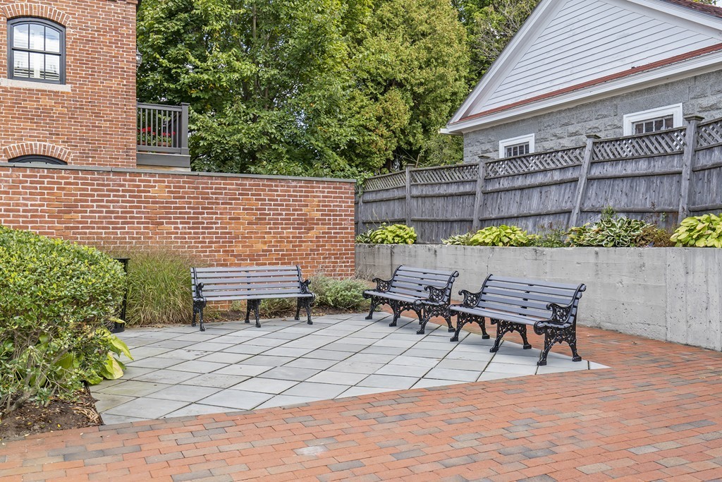 423 Hope Street, Unit 1A Bristol, RI 02809 - Photo 23 of 26 a table and chairs sitting in front of a house