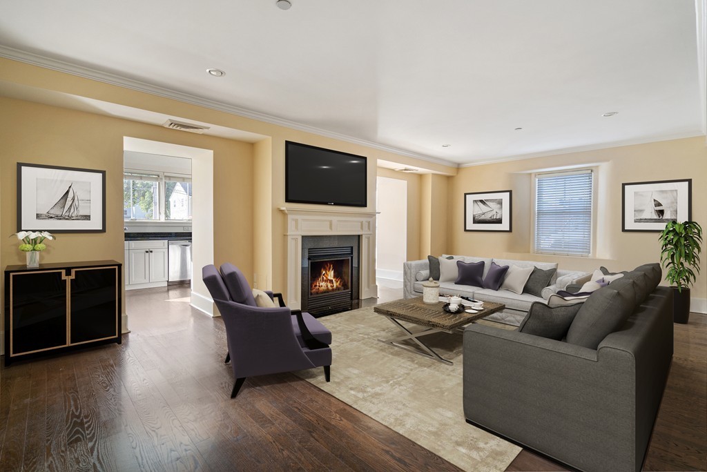 423 Hope Street, Unit 1A Bristol, RI 02809 - Photo 4 of 26 a living room with furniture a flat screen tv and a fireplace