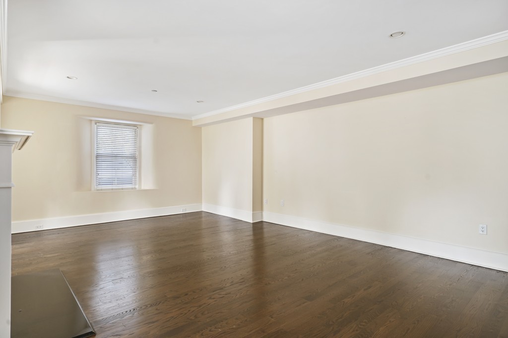 423 Hope Street, Unit 1A Bristol, RI 02809 - Photo 7 of 26 an empty room with wooden floor and windows