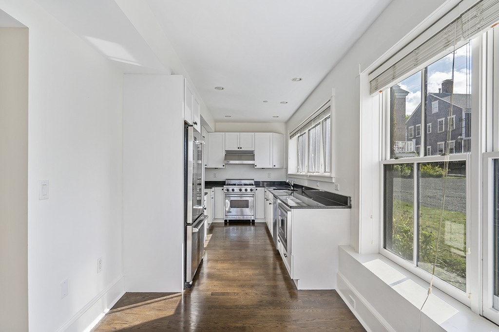423 Hope Street, Unit 1A Bristol, RI 02809 - Photo 10 of 26 a kitchen with stainless steel appliances granite countertop a stove and a refrigerator
