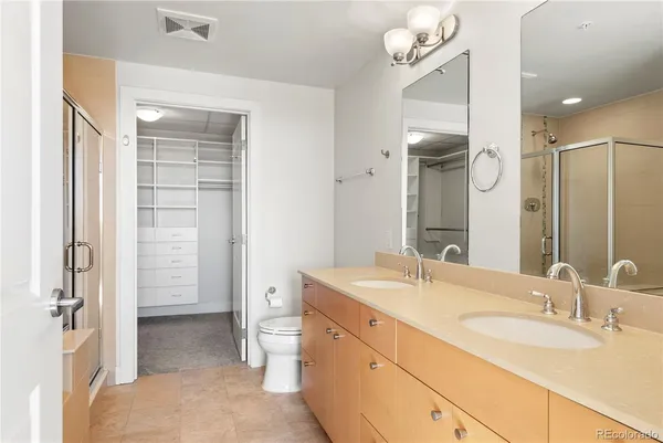 a spacious bathroom with a double vanity sink mirror and double