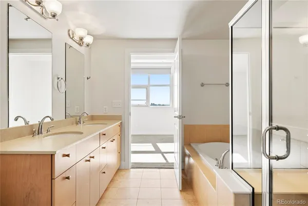 a bathroom with a tub sink and mirror