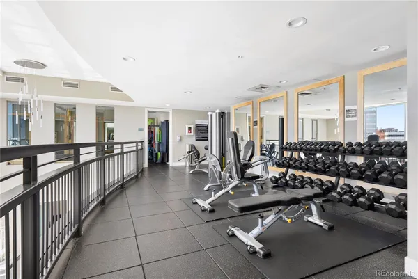 a room with gym equipment and view of living room