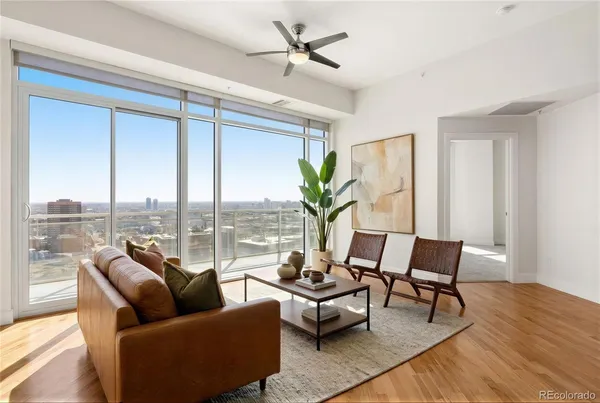 a living room with furniture tv and a large window