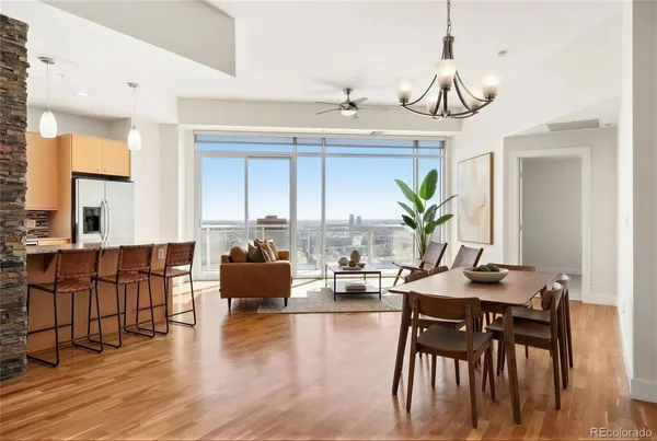 a living room with furniture a wooden floor and a chandelier
