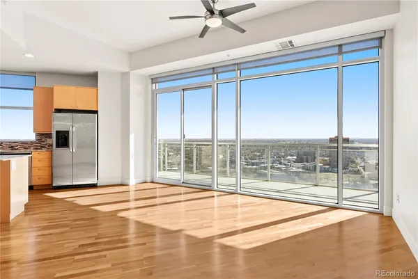 a view of a room with a floor to ceiling window and an empty room