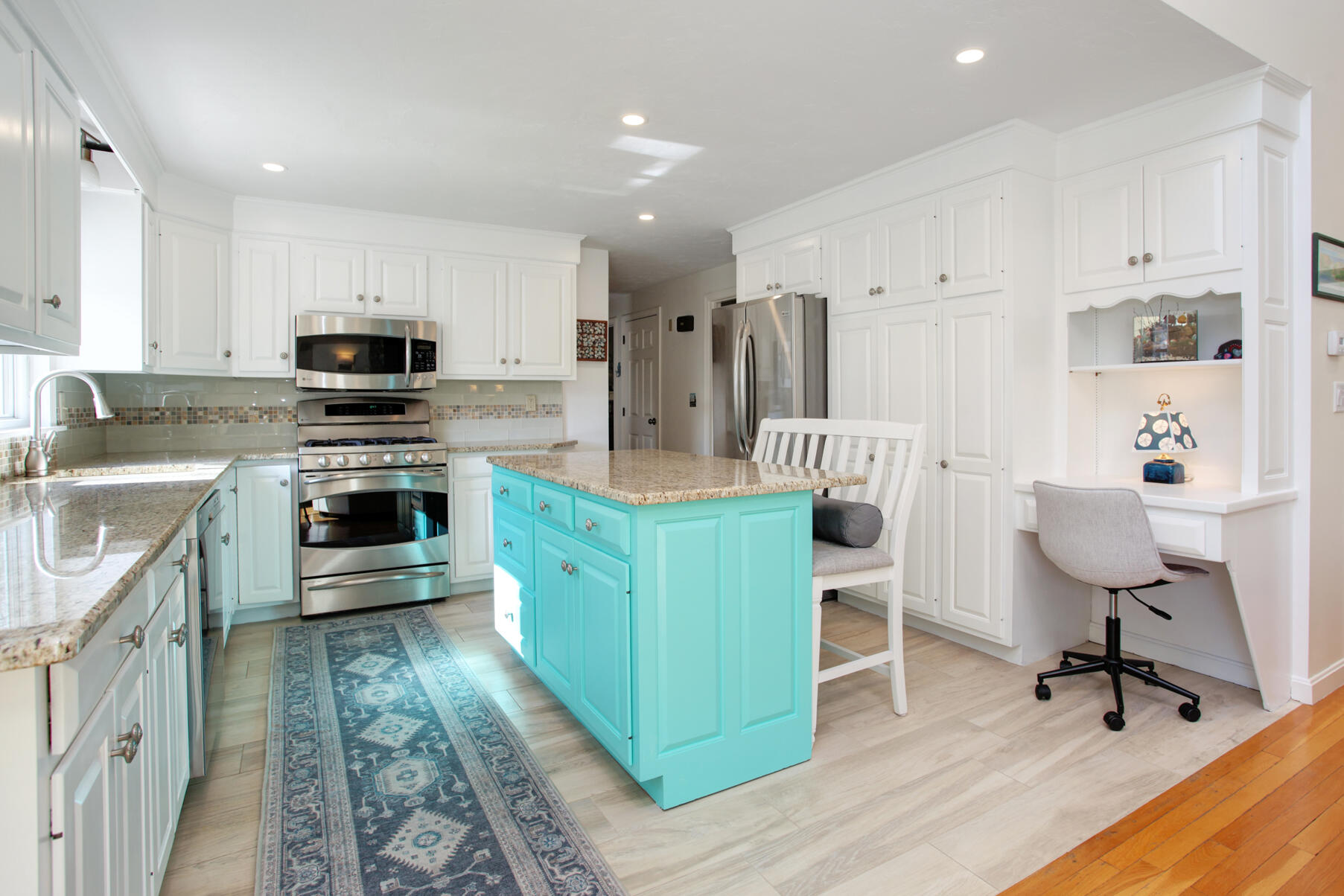 282 Elliott Road Centerville, MA 02632 - Photo 5 of 51 a kitchen with kitchen island stainless steel appliances a stove a sink a microwave a refrigerator and cabinets