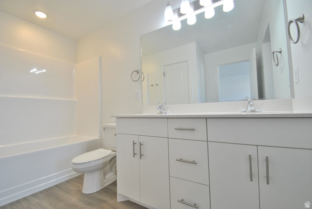 1219 West 1870 South Logan, UT 84321 - Photo 8 of 18 Primary Bedroom attached Bathroom with double vanity, light wood-style floors, shower / bathtub combination, and recessed lighting