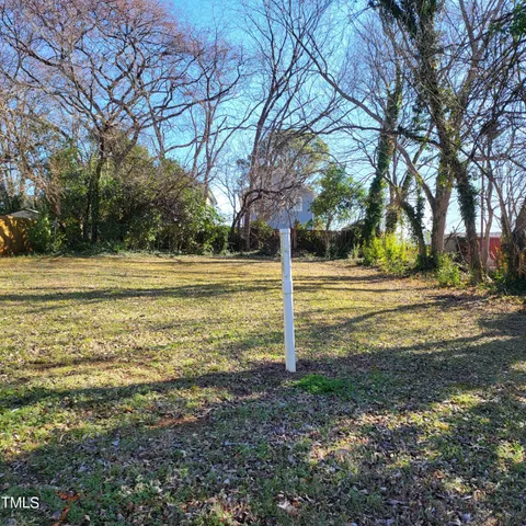 a view of a yard with a tree