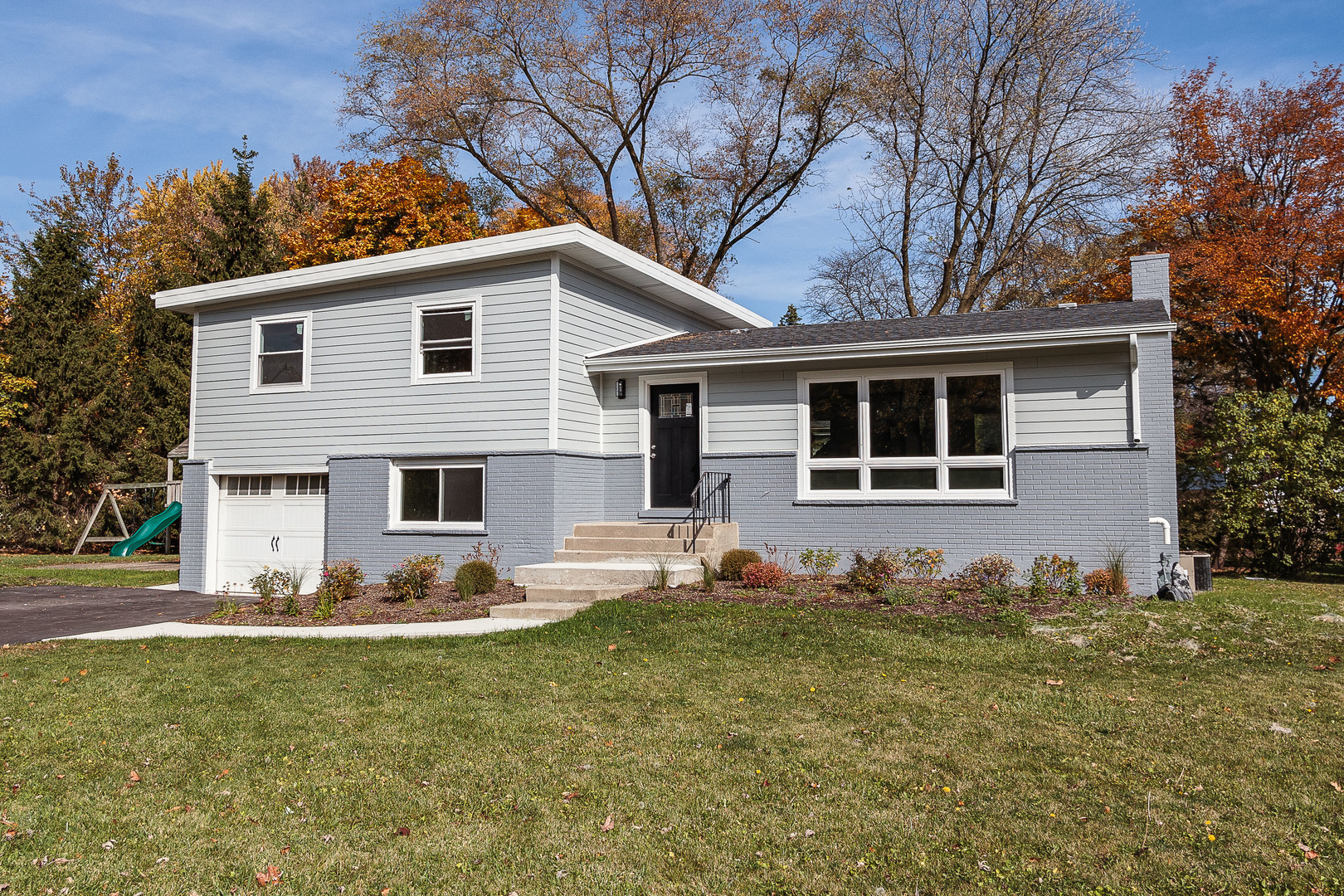 a front view of a house with garden