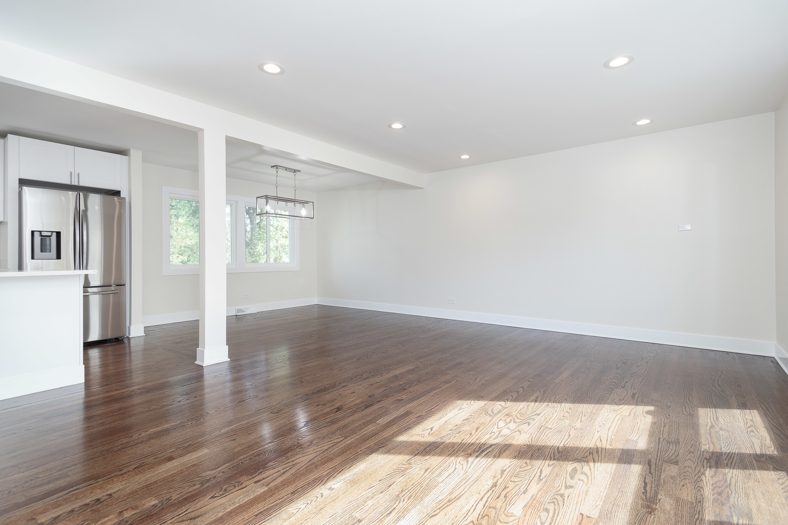 601 Pine Street Deerfield, IL 60015 - Photo 4 of 23 a view of an empty room with wooden floor and a kitchen