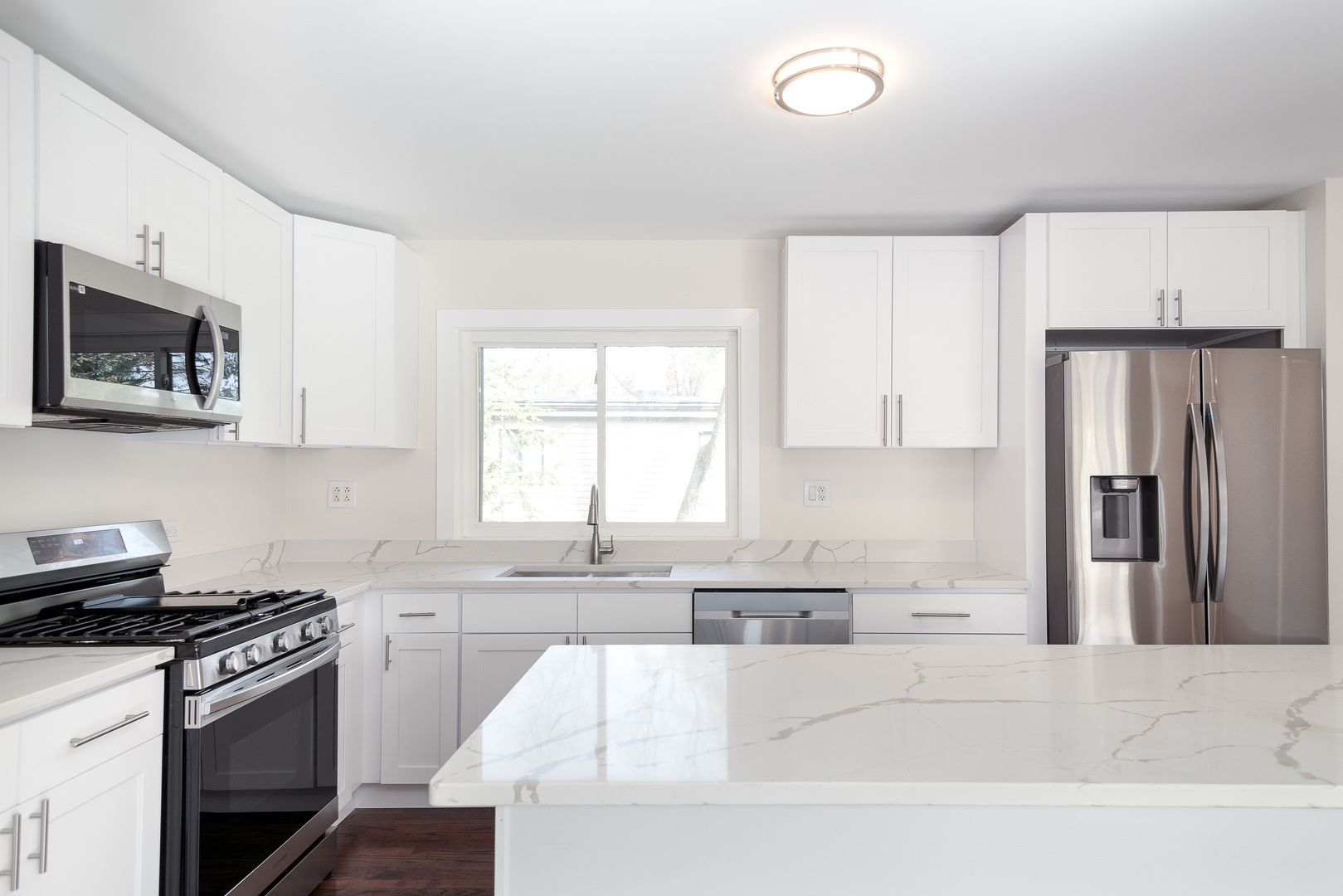 601 Pine Street Deerfield, IL 60015 - Photo 6 of 23 a kitchen with stainless steel appliances granite countertop a stove a sink and a refrigerator