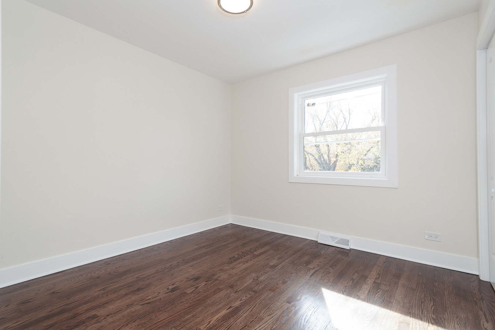 601 Pine Street Deerfield, IL 60015 - Photo 8 of 23 an empty room with wooden floor and windows