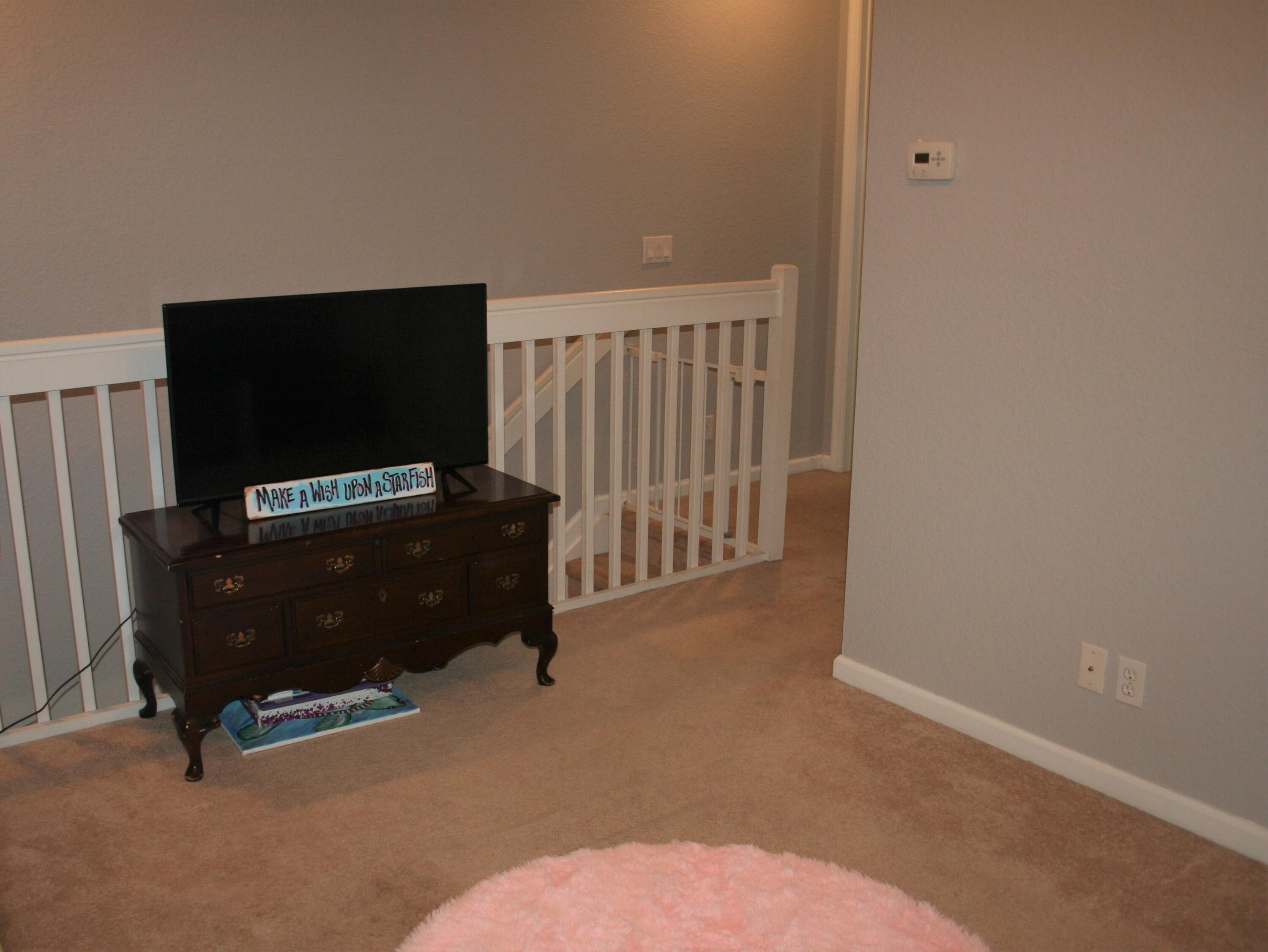 9469 Southwest Purple Martin Way Stuart, FL 34997 - Photo 13 of 23 a living room with furniture and a flat screen tv