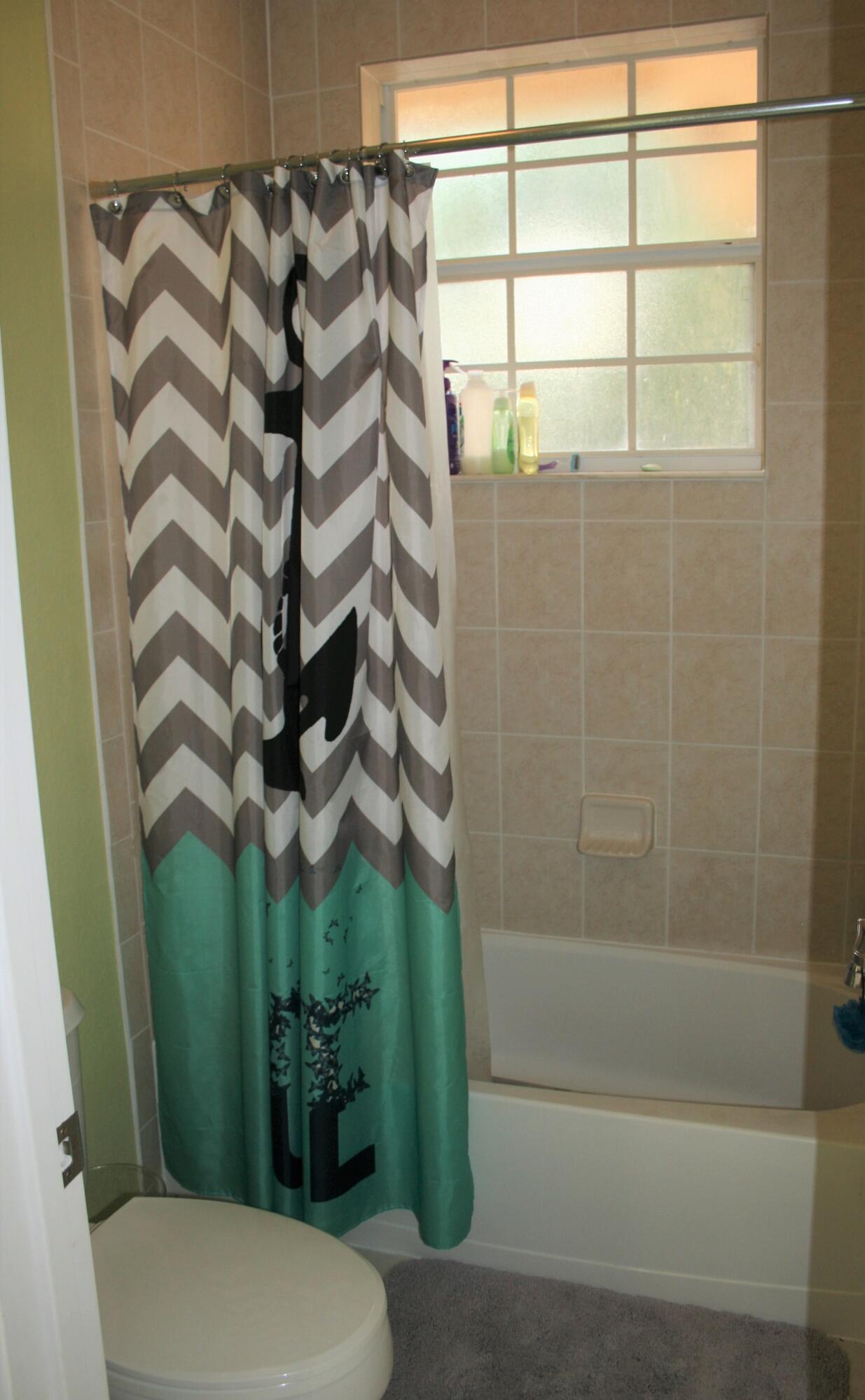 9469 Southwest Purple Martin Way Stuart, FL 34997 - Photo 17 of 23 a bathroom with a toilet and shower