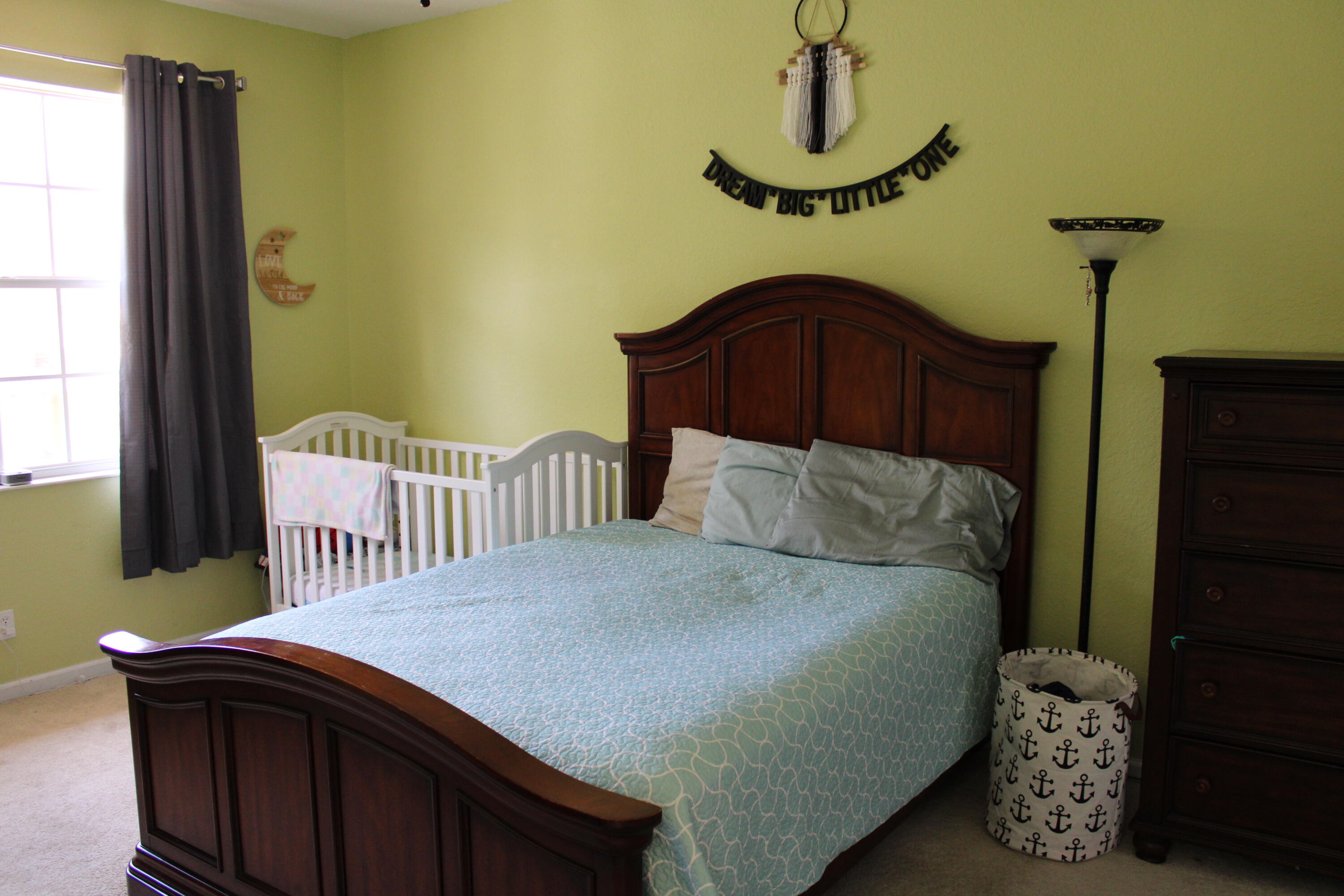 9469 Southwest Purple Martin Way Stuart, FL 34997 - Photo 18 of 23 a bedroom with a bed and window