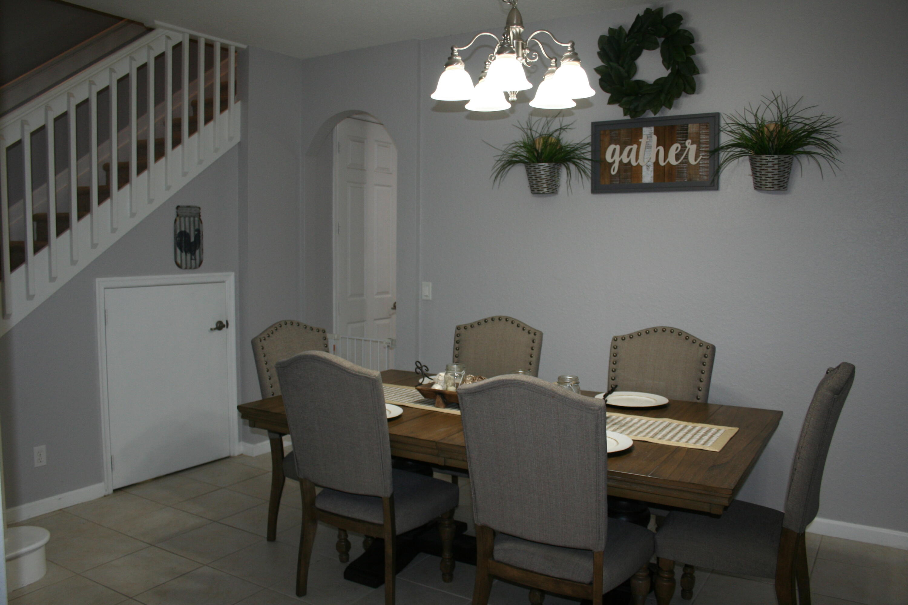 9469 Southwest Purple Martin Way Stuart, FL 34997 - Photo 4 of 23 a view of a dining room with furniture and chandelier