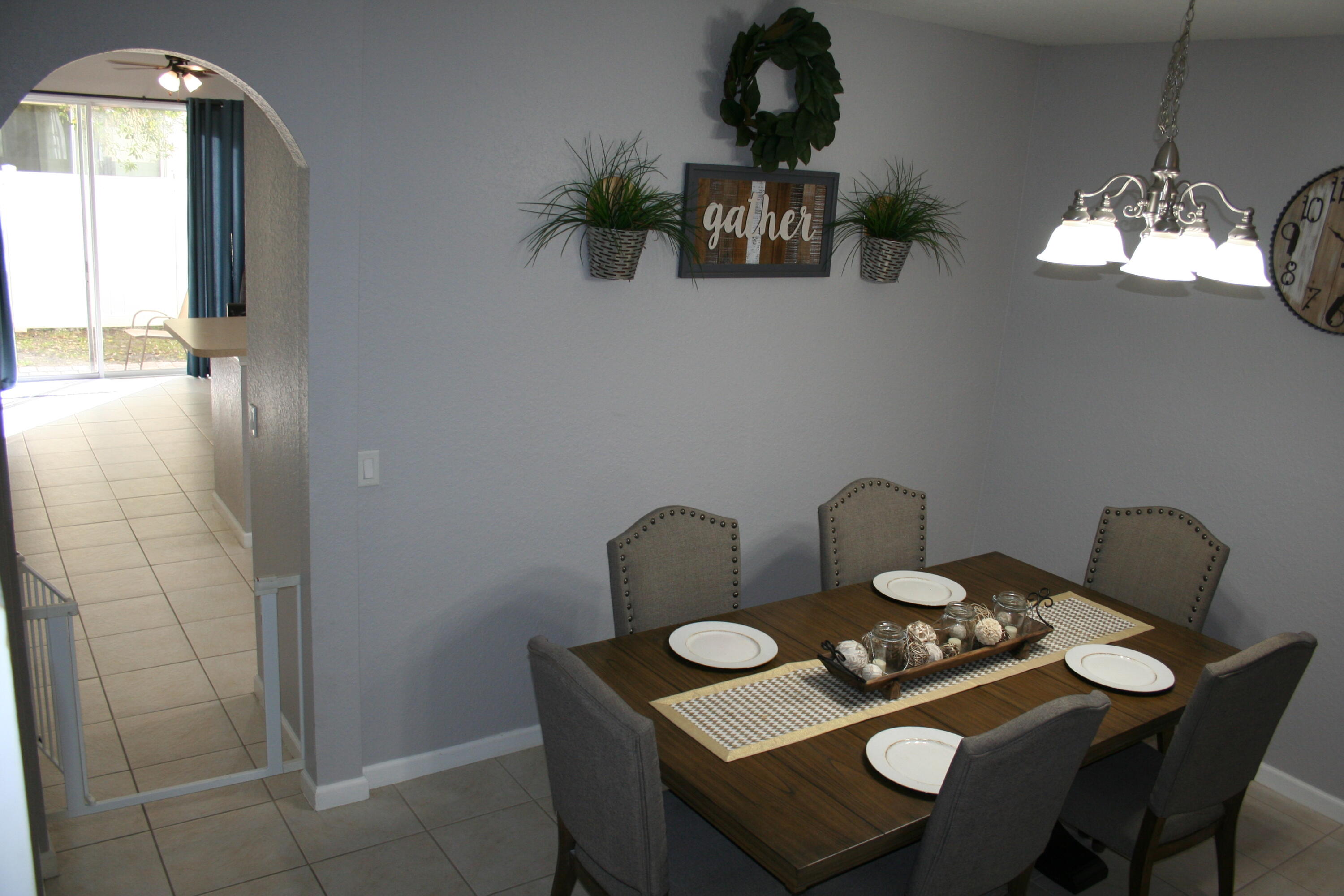 9469 Southwest Purple Martin Way Stuart, FL 34997 - Photo 5 of 23 a dining room with furniture and chandelier