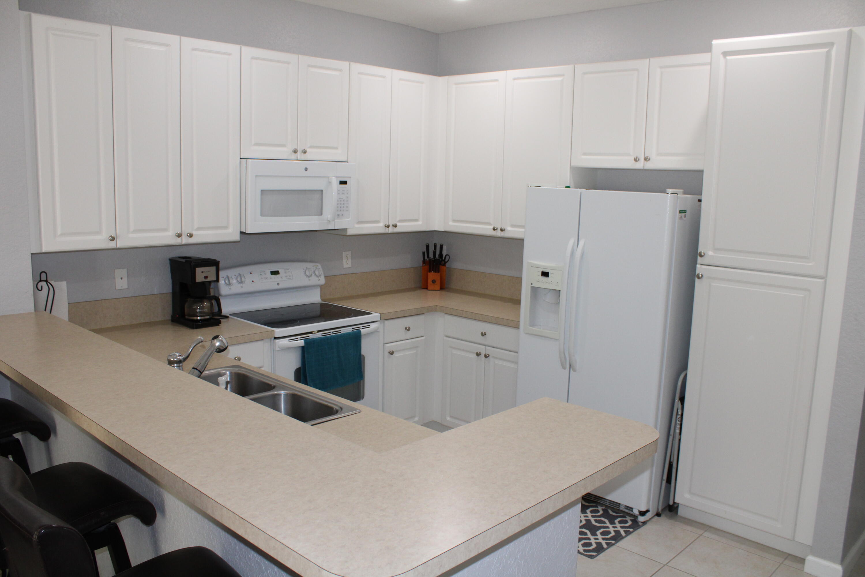 9469 Southwest Purple Martin Way Stuart, FL 34997 - Photo 6 of 23 a kitchen with a cabinets and white appliances