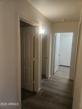 a view of a big room with wooden floor and staircase